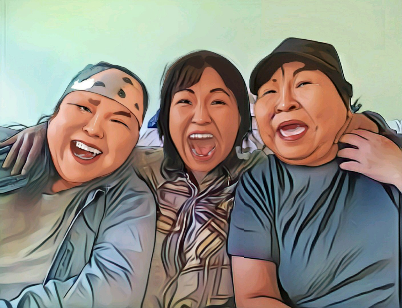 Three Inuit with their arms around each other sharing in laughter