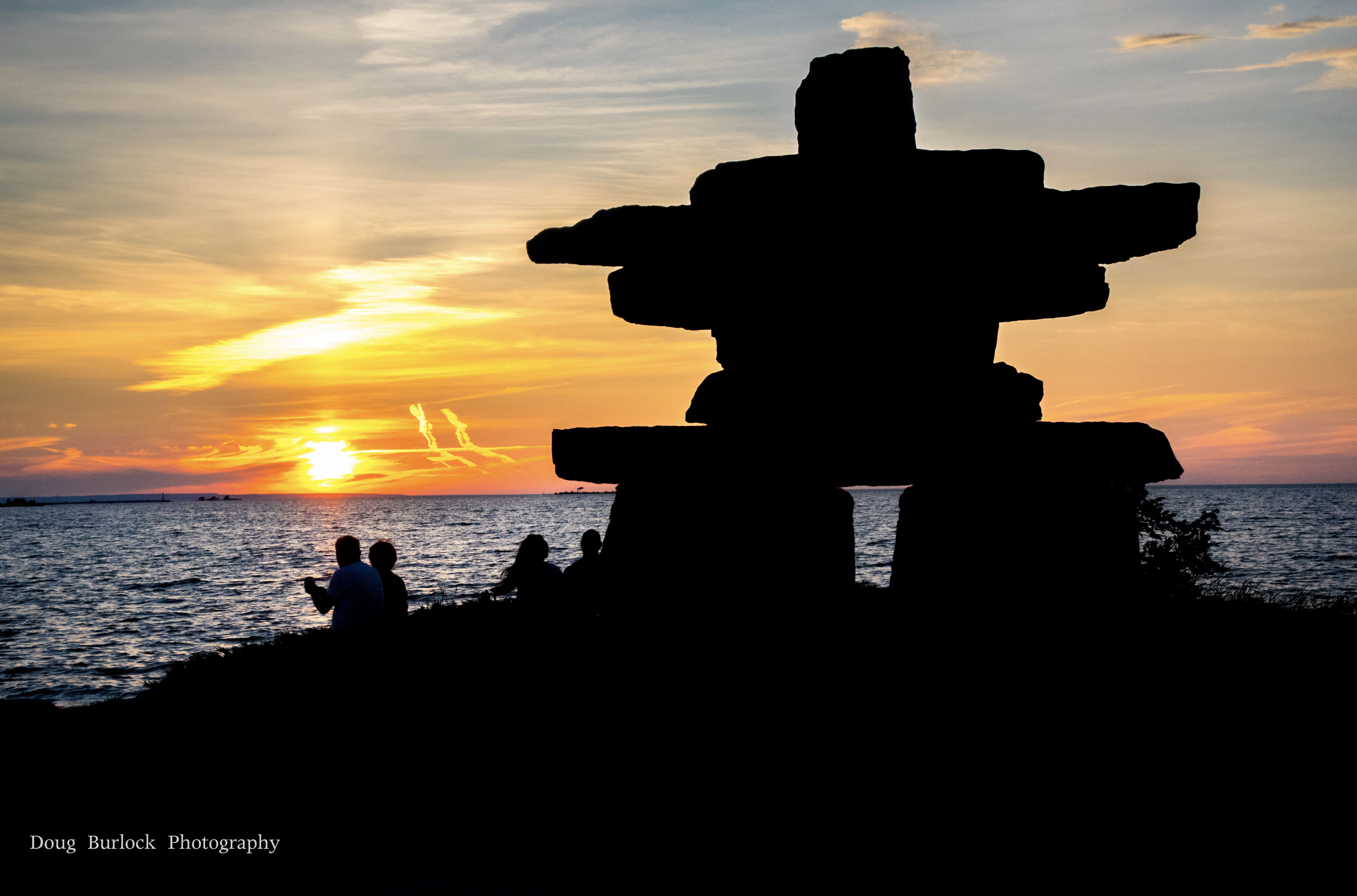 Photo of the Inukshuk with sun setting in the background by Doug Burlock