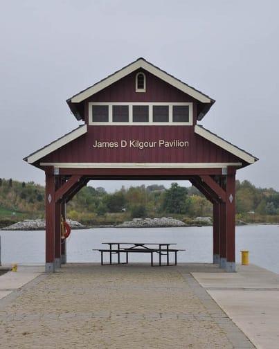 Wooden archway above a picnic table sitting at the water's edge