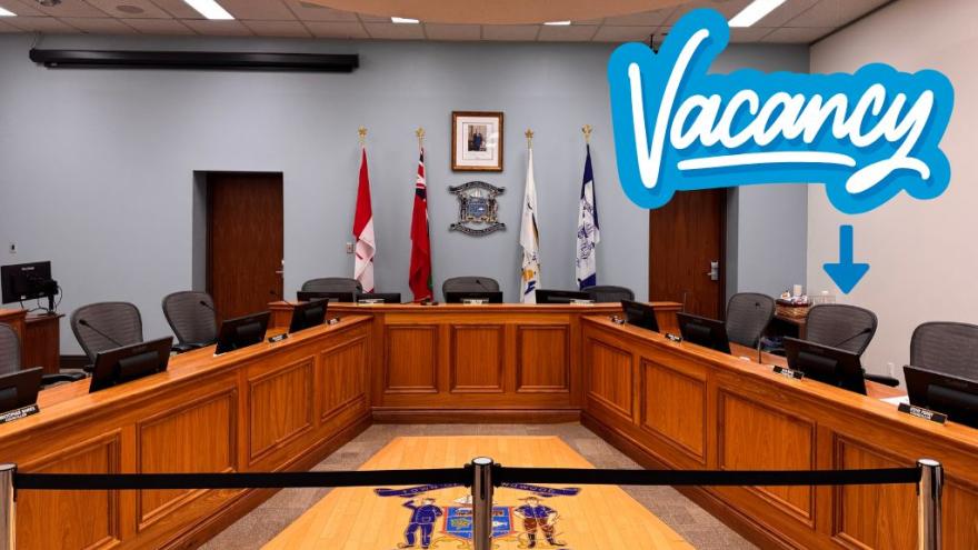 image of Council chambers. Text: Vacancy with arrow pointed to empty seat