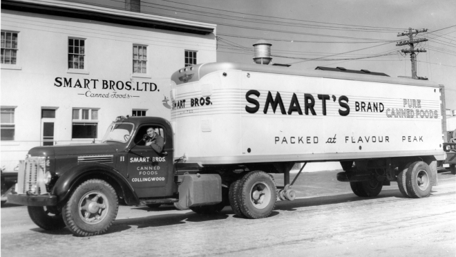 Black and White of a truck outside a white building