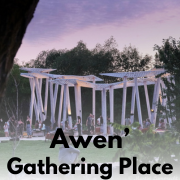 awen' at dusk under a purple-pink sky with people
